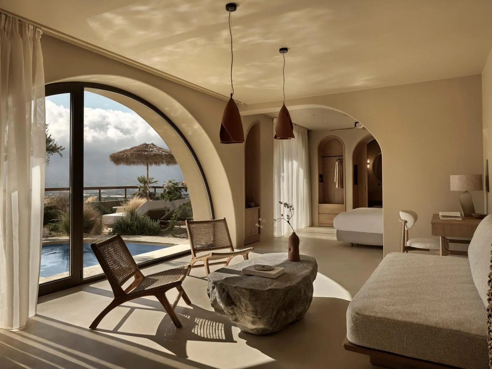 Arched suite interior with pool and sea view