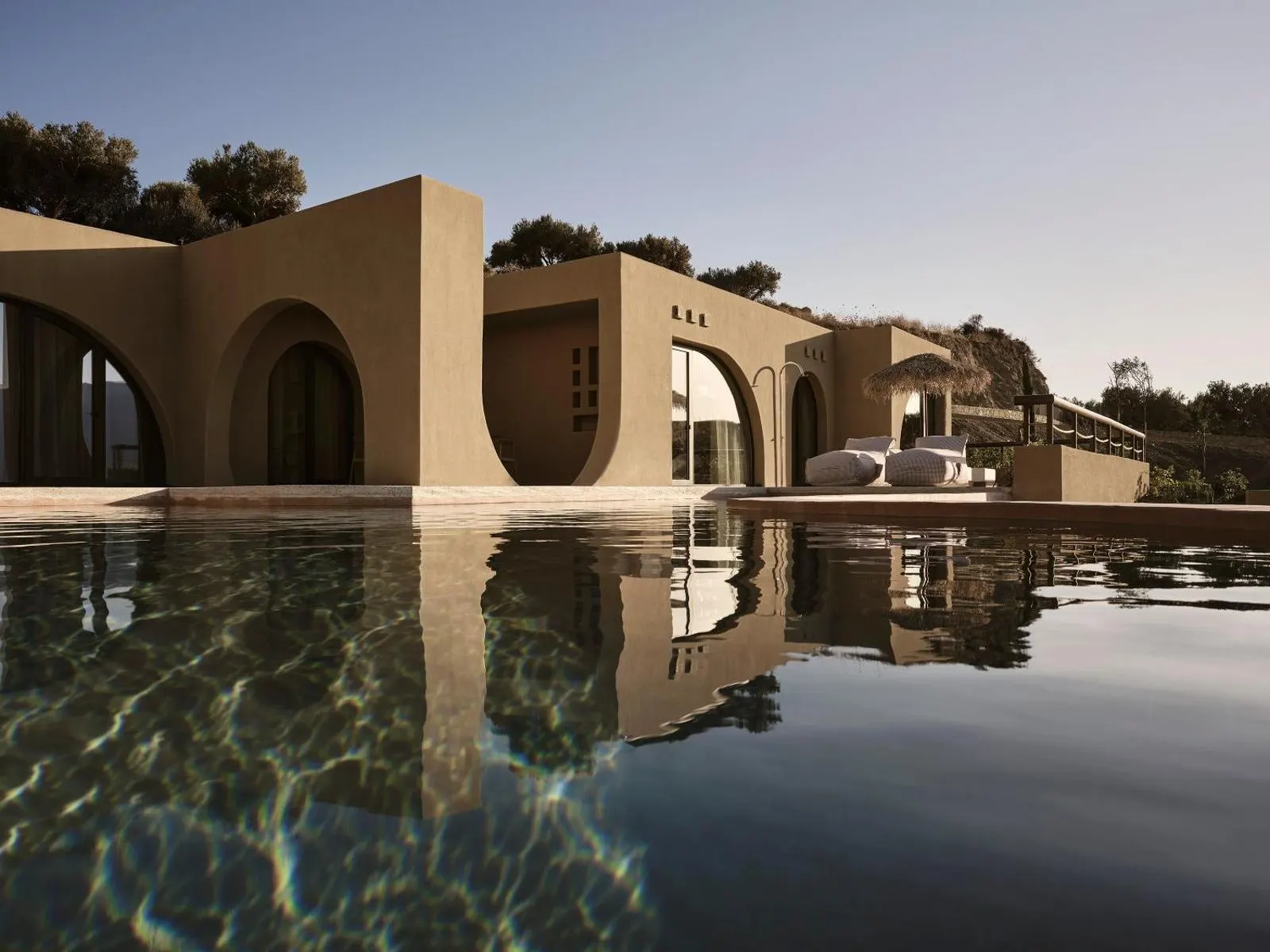 Modern villa with arches beside infinity pool