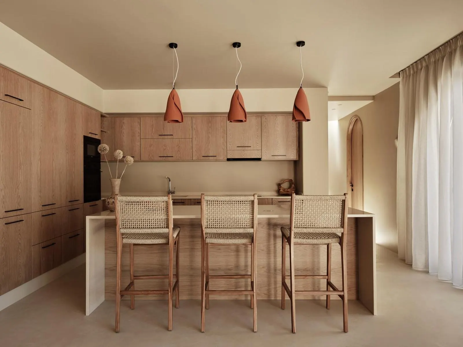 Wooden kitchen with rattan bar stools
