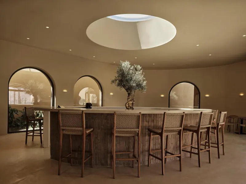 Circular bar with arched windows and olive tree
