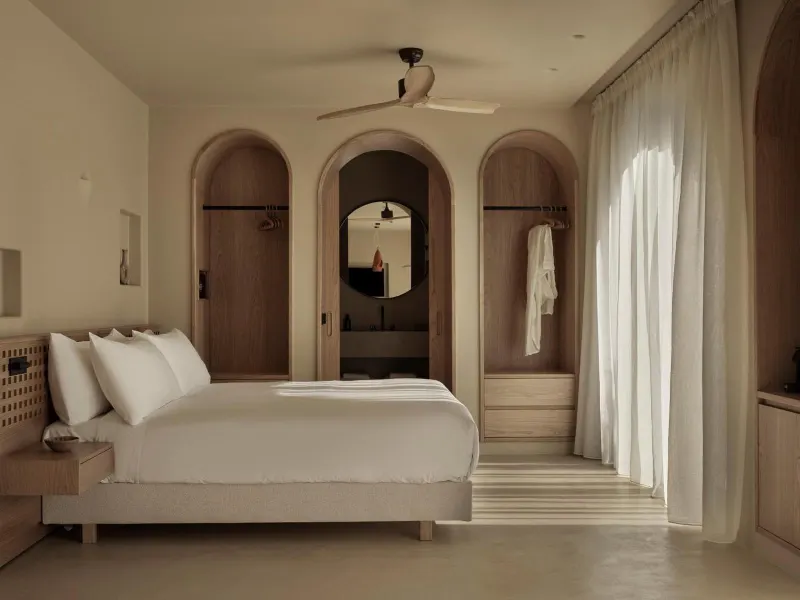 Bedroom with arched wardrobe doors and mirror