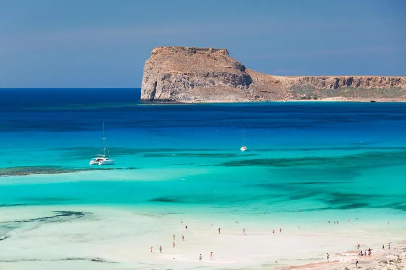 Turquoise bay with cliff and boats