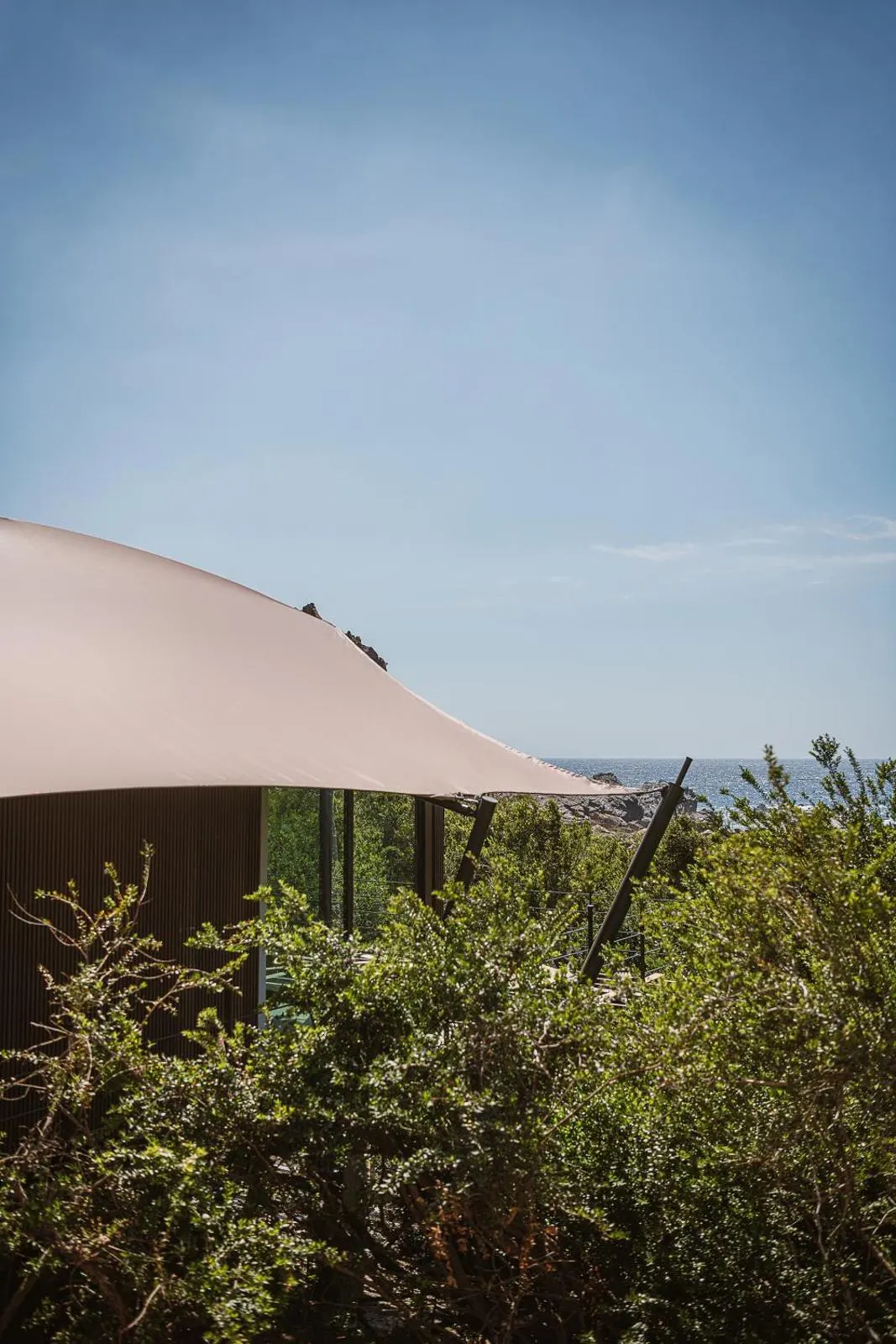 Curved tent roof against sea horizon