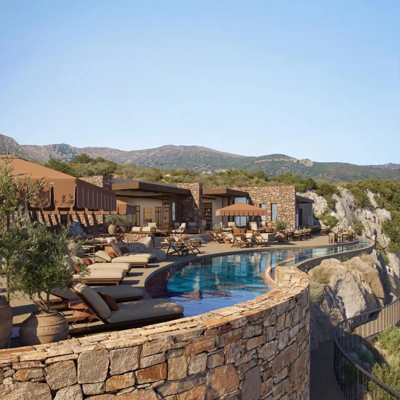 Resort pool deck overlooking mountains and cliffs