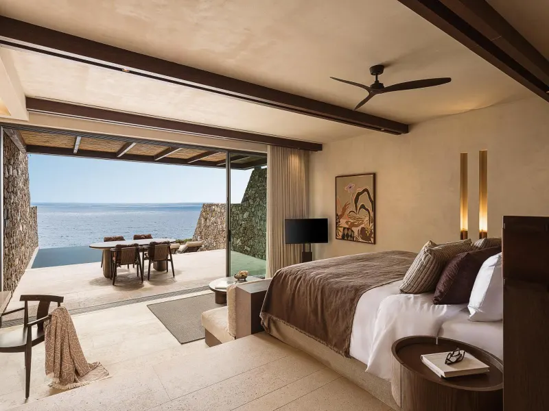 Bedroom with ocean view and outdoor dining area