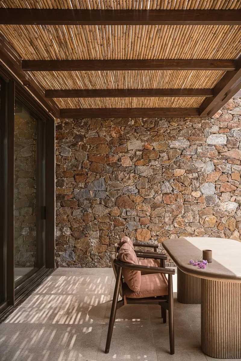 Stone wall patio with wooden chair and table