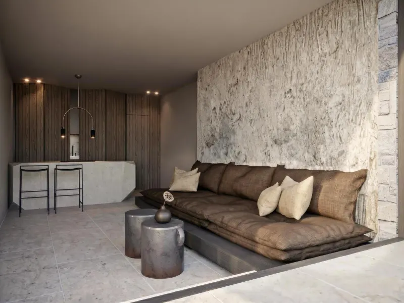 Lounge area with textured concrete wall and sofa