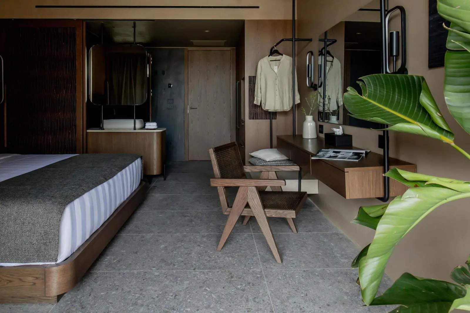 Bedroom with open wardrobe and stone floor