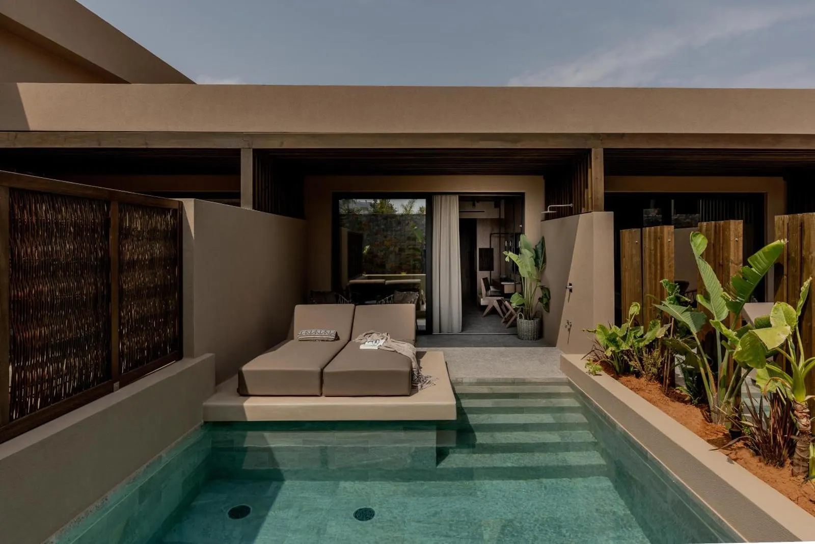 Private pool terrace with loungers and greenery