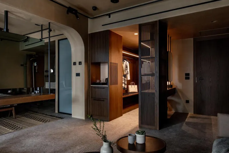 Dim suite hallway with wooden bar area