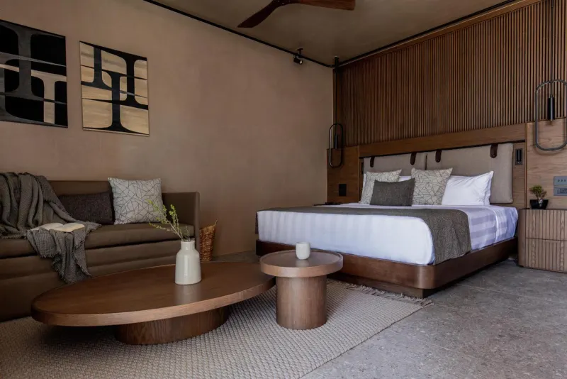 Bedroom with sofa, coffee tables and artwork