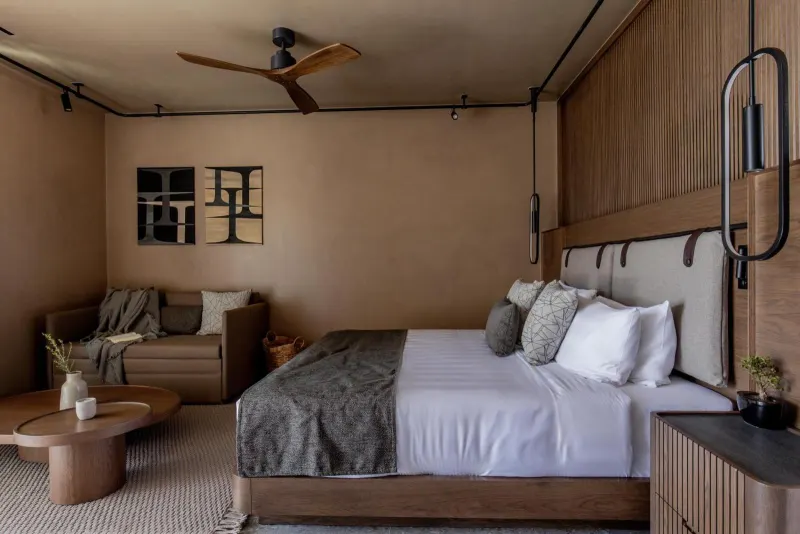 Bedroom with ceiling fan and lounge seating