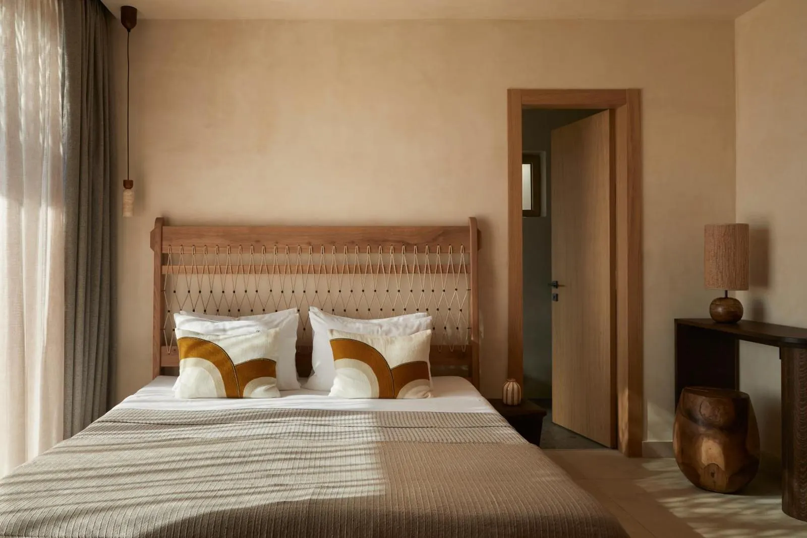 Bedroom with woven headboard and neutral linens