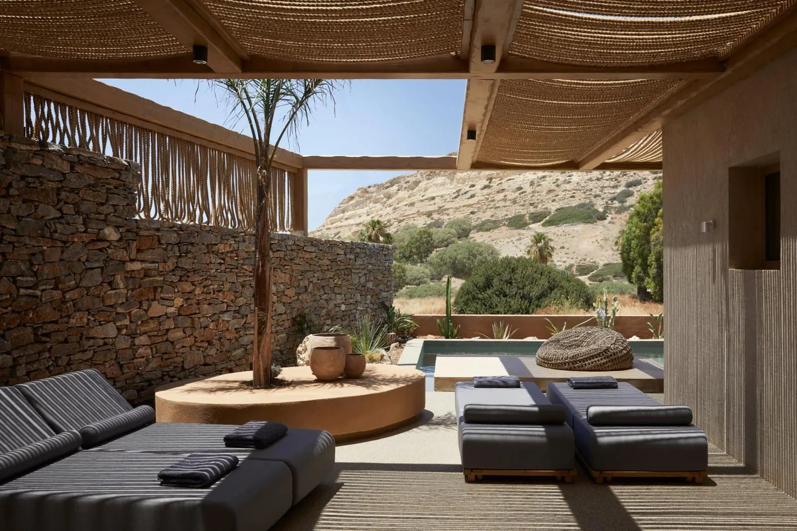 Shaded lounge area with daybeds and mountain view