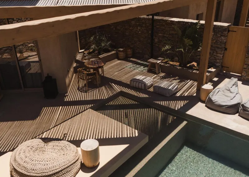 Aerial view of pool deck with shaded seating