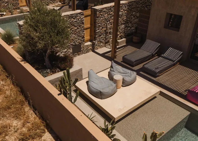 Rooftop view of poolside loungers and cacti garden