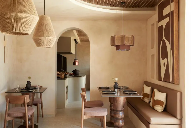 Dining area with woven pendant lights and archway