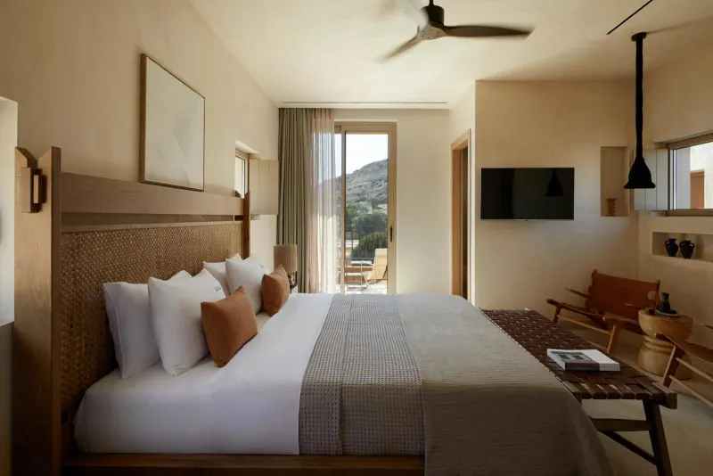 Bedroom with ceiling fan and balcony access