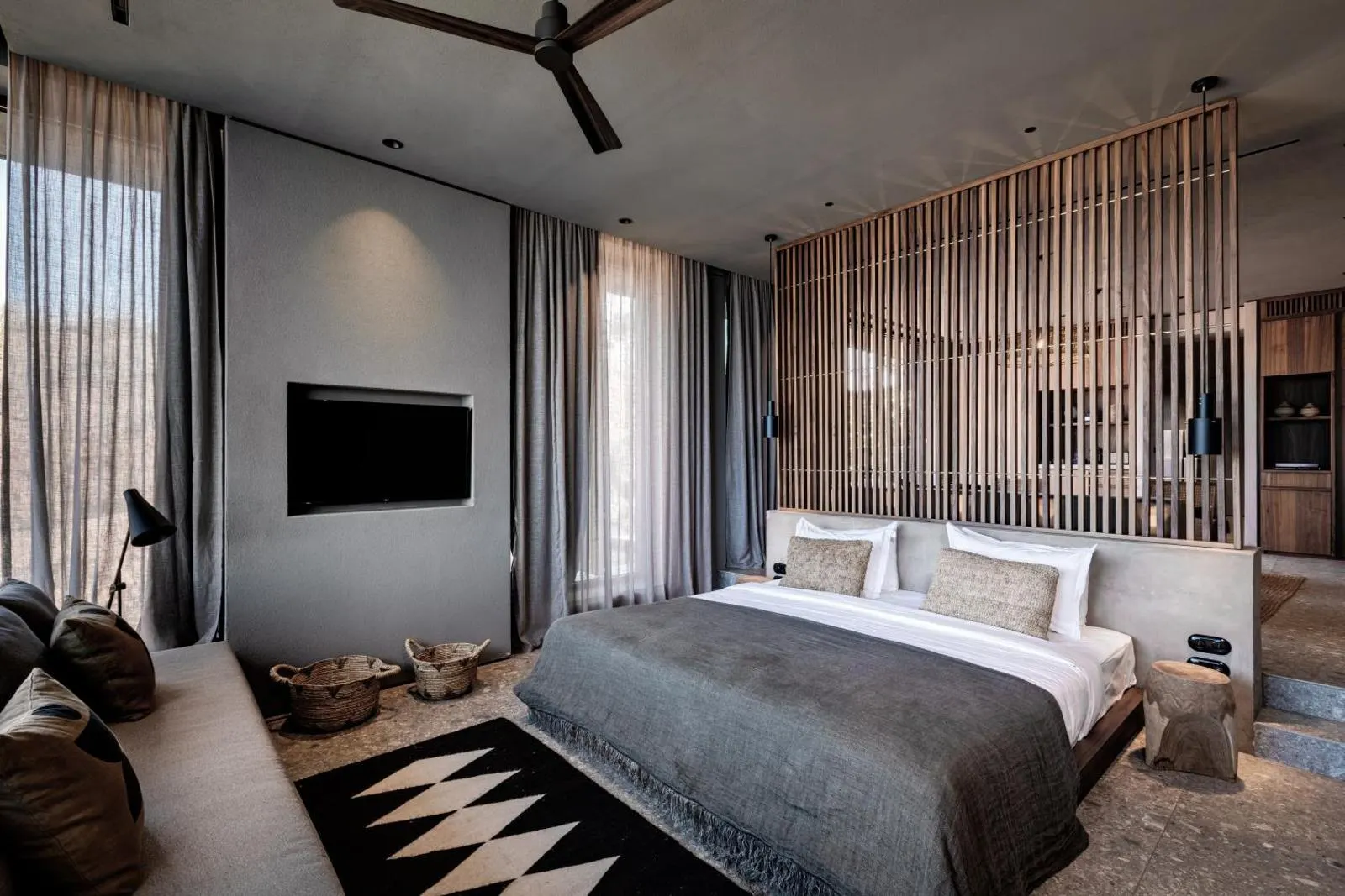 Modern bedroom with wooden slat wall and TV