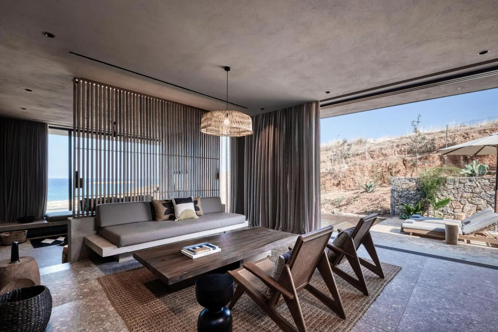 Living area with sea view through open glass doors
