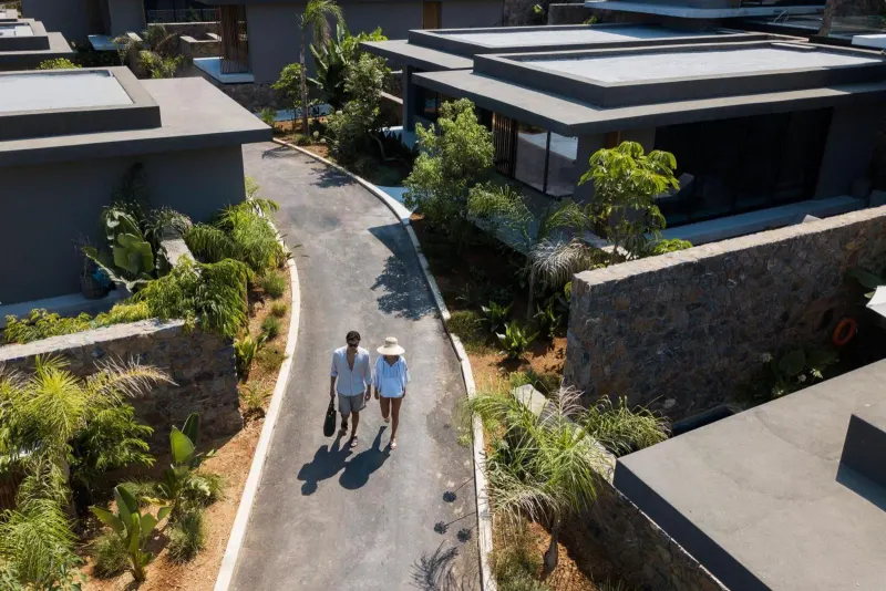 Aerial view of couple walking among villas