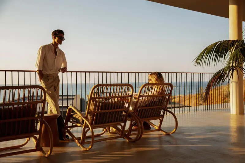 Couple relaxing on terrace overlooking the sea