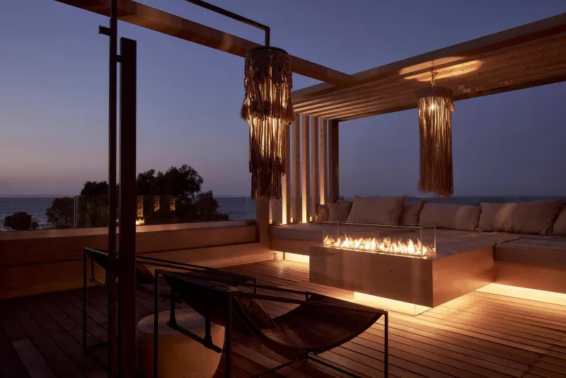 Elegant lounge terrace with fire pit at dusk