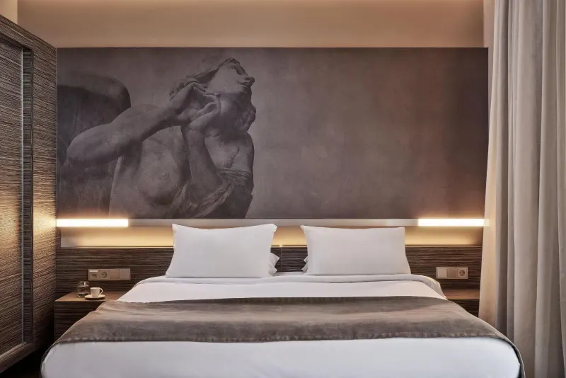 Bed with artistic mural headboard in modern room