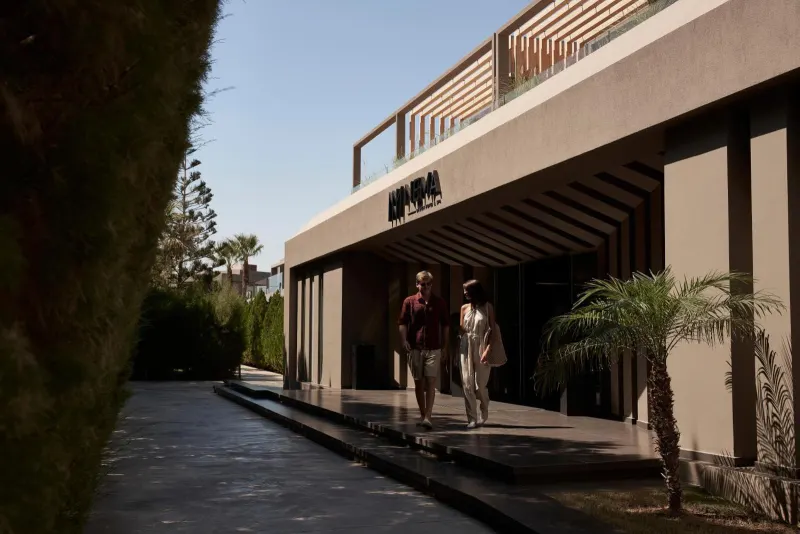 Couple walking along hotel entrance corridor
