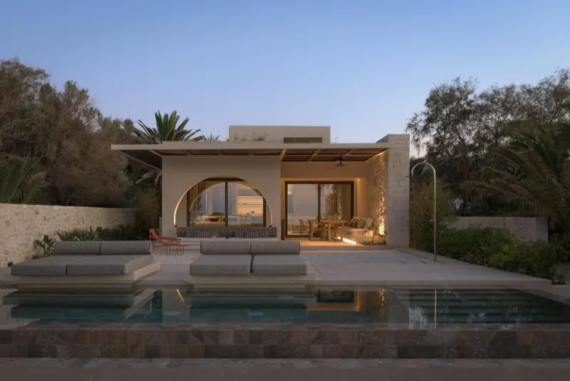 Villa exterior with pool at dusk