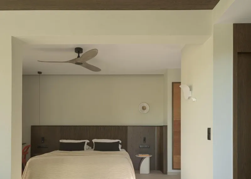 Bedroom with ceiling fan and wooden headboard