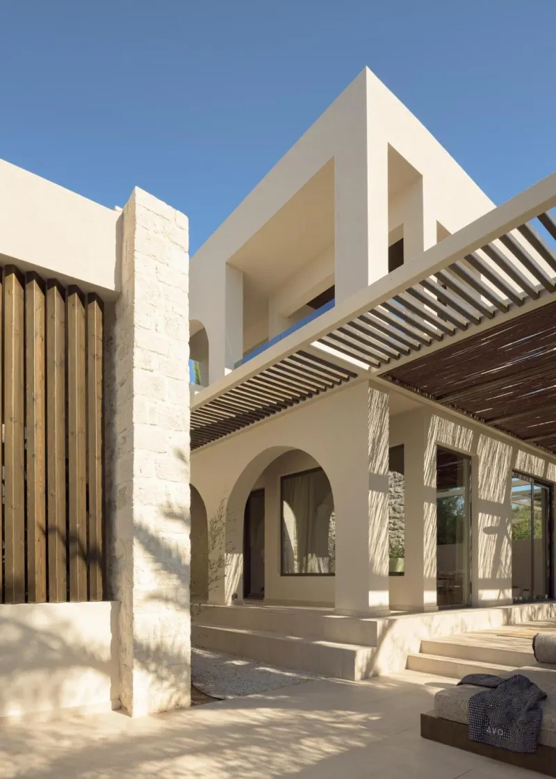 Modern villa facade with wooden slats and arches