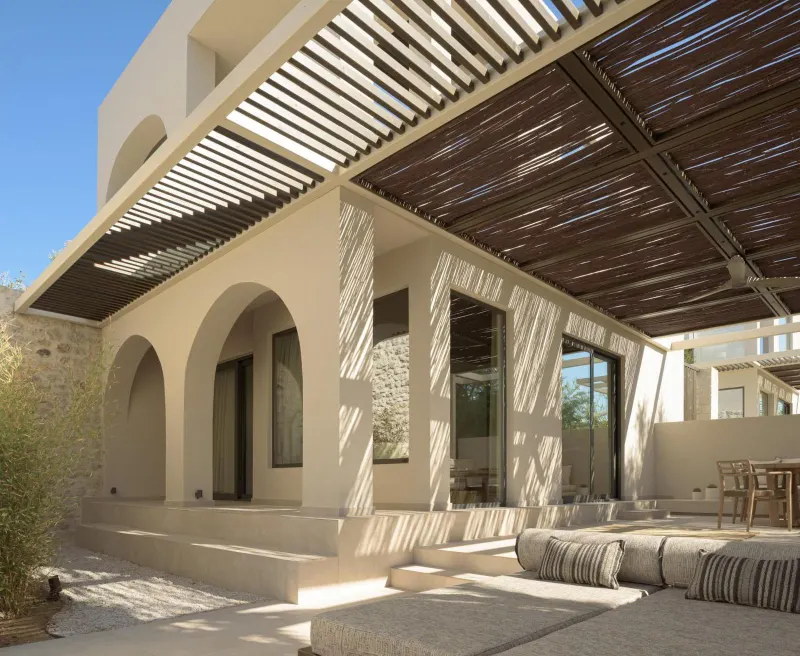 Villa exterior with pergola and patterned shadows