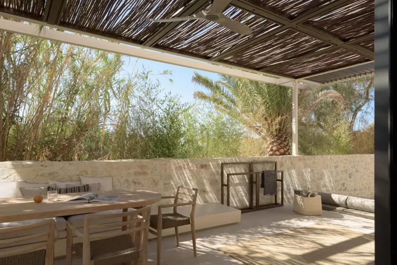 Covered outdoor dining area with greenery view