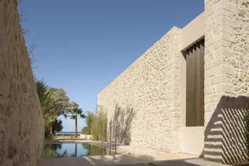 Stone corridor leading to sea view pool