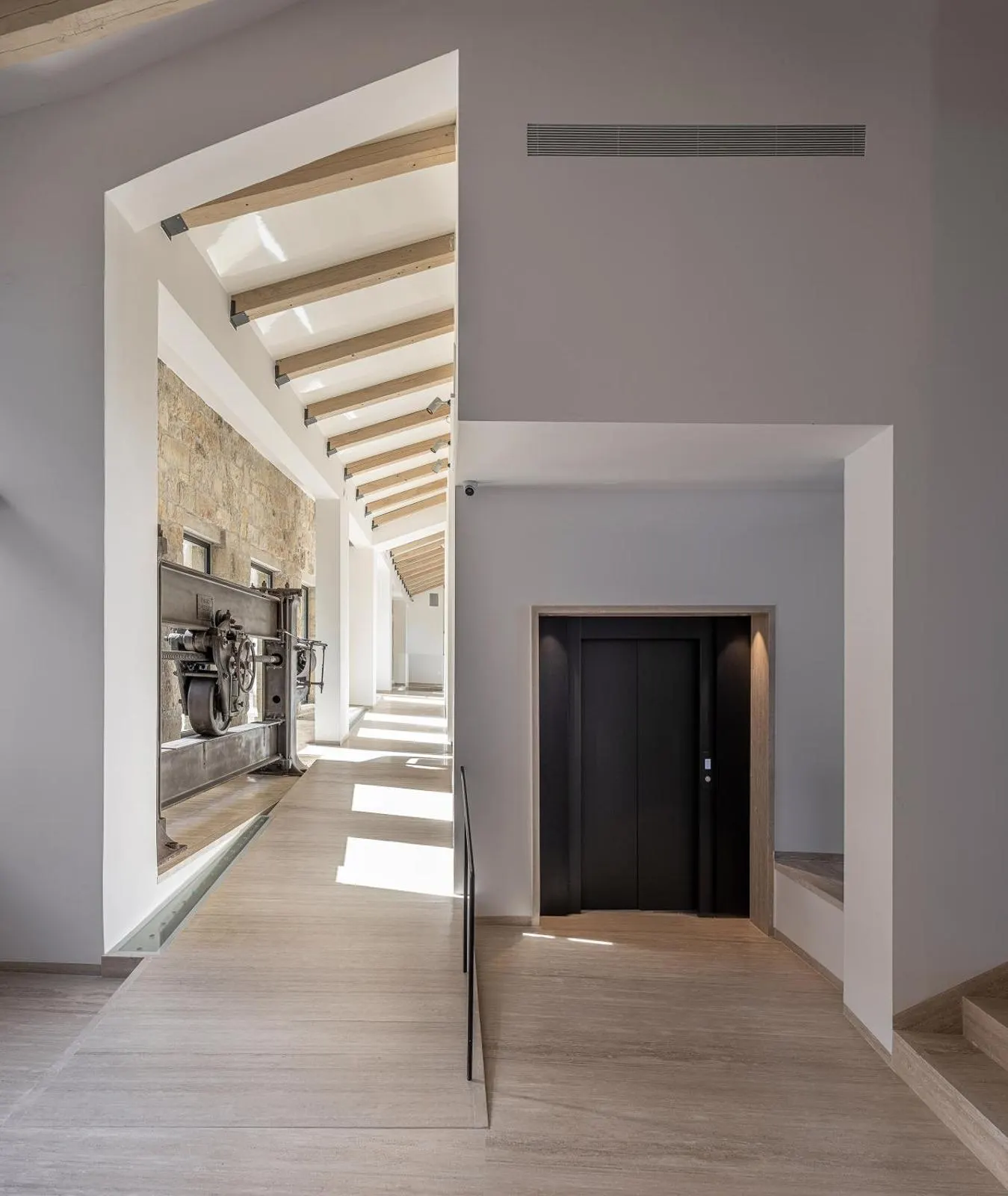 Modern hallway with wood beams and stone accent wall