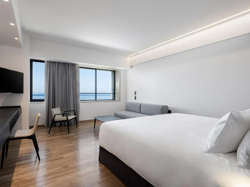 Bedroom with sofa and sea view window