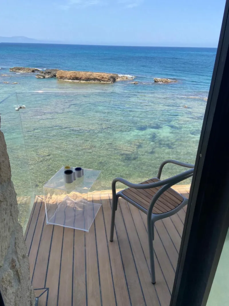 Balcony deck chair overlooking turquoise sea