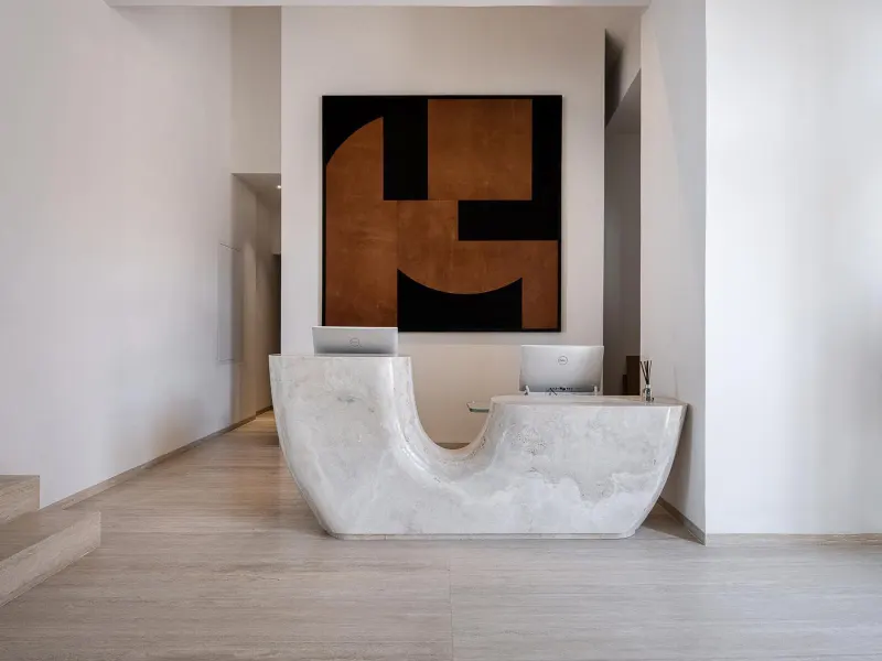Marble reception desk with abstract wall art