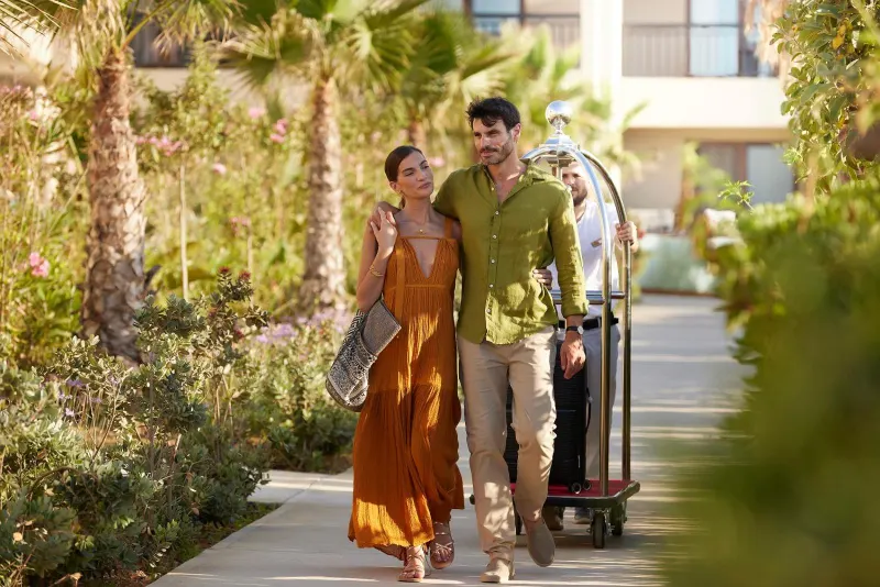 Couple walking through lush garden pathway
