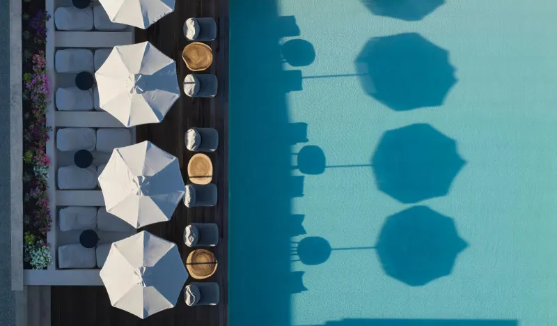 Aerial view of pool umbrellas and shadows