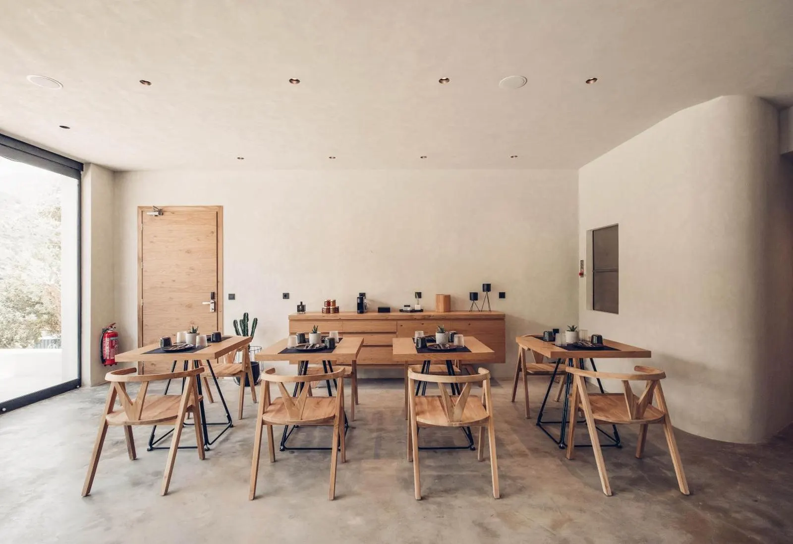Minimalist dining area with wooden tables and chairs