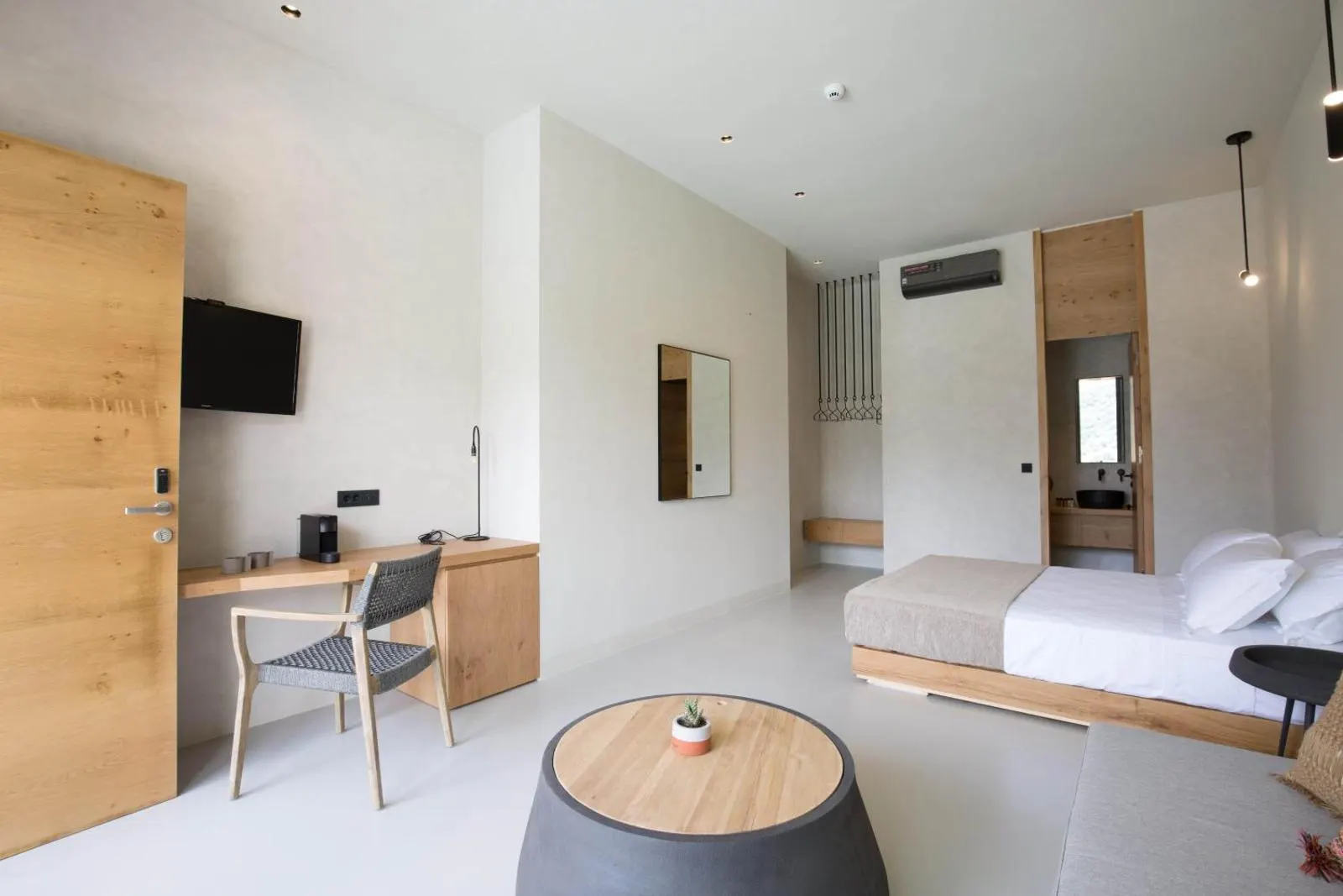 Modern guest room with desk and bed