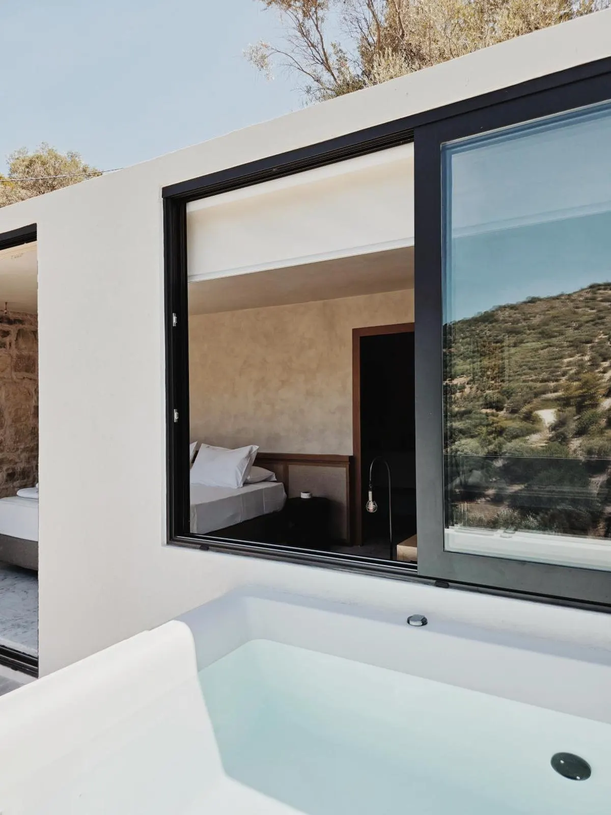 Outdoor hot tub with view into bedroom
