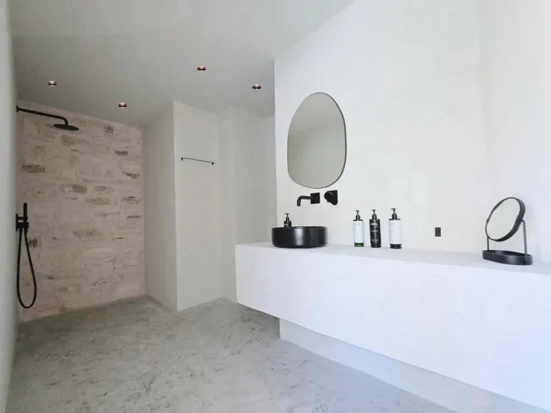 Bathroom with stone shower and floating vanity