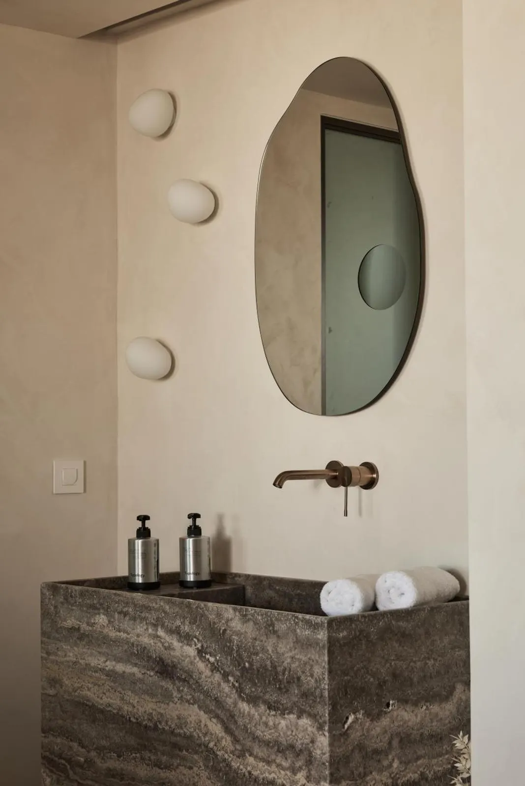 Stone vanity sink with oval mirror