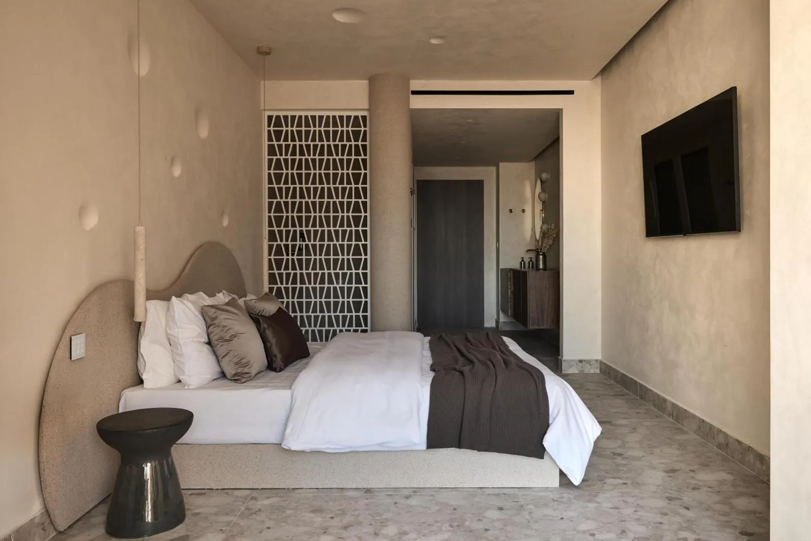 Bedroom with patterned wall panel and TV