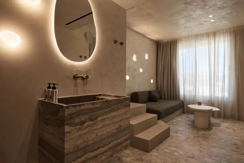 Suite with sink, sofa, and staircase