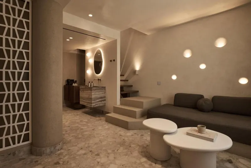 Living area with sofa, steps, and patterned screen