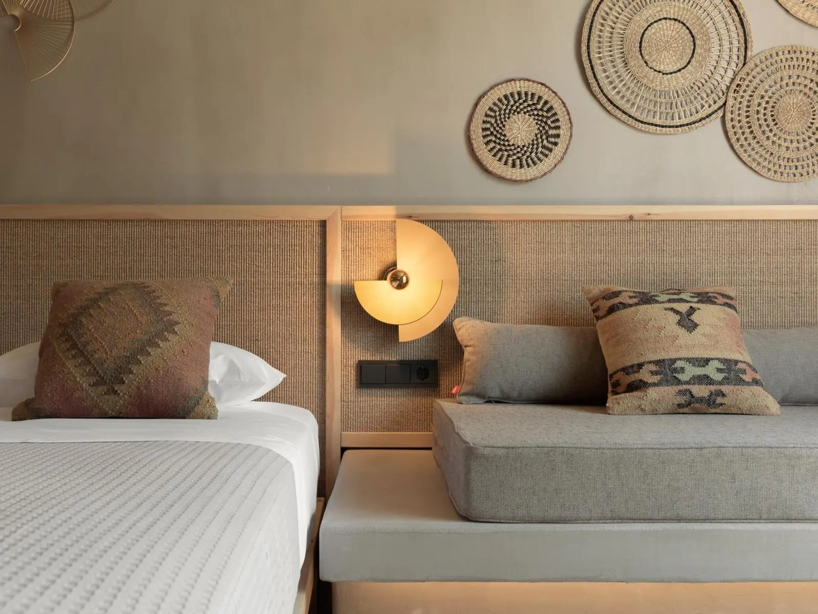 Bed with woven wall decor and cushions